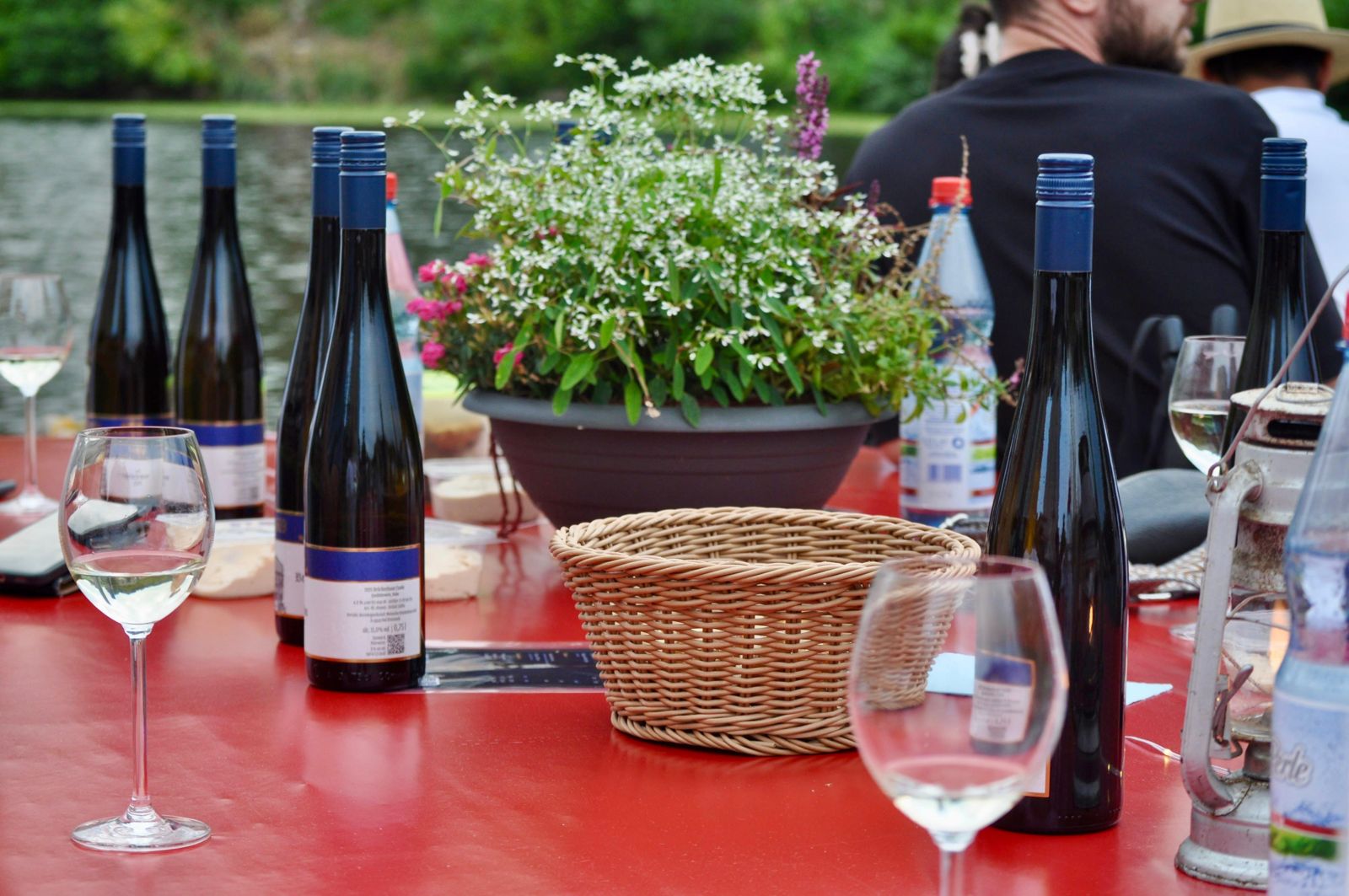 Weinflaschen und Gläser auf der langen Tafel an Bord